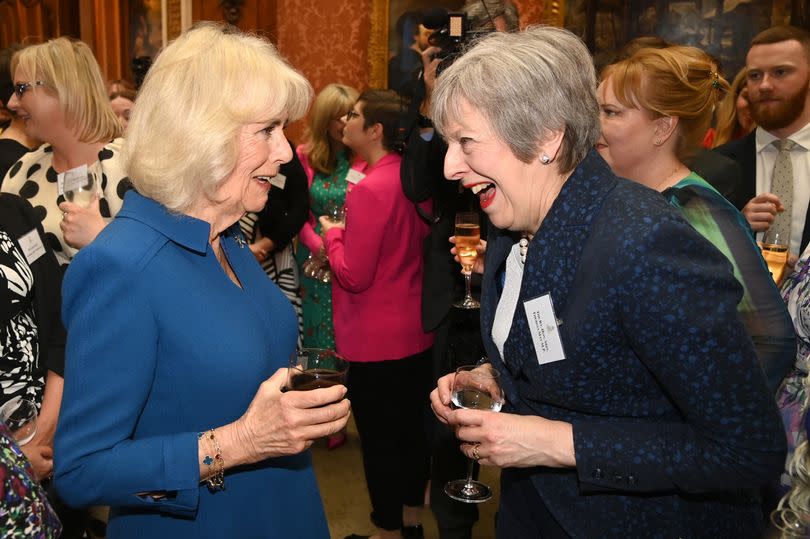 Queen Camilla talks with former Prime Minister Theresa May at the reception