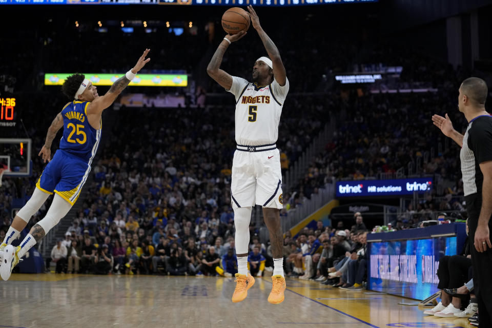 Denver Nuggets guard Kentavious Caldwell-Pope (5) shoots a 3-point basket next to Golden State Warriors guard Lester Quiñones (25) during the first half of an NBA basketball game Sunday, Feb. 25, 2024, in San Francisco. (AP Photo/Godofredo A. Vásquez)