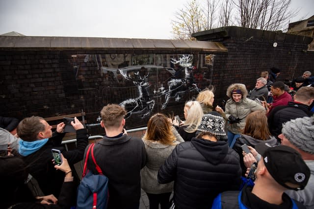 Workmen use perspex sheeting to protect a new Banksy artwork in Birmingham’s Jewellery Quarter