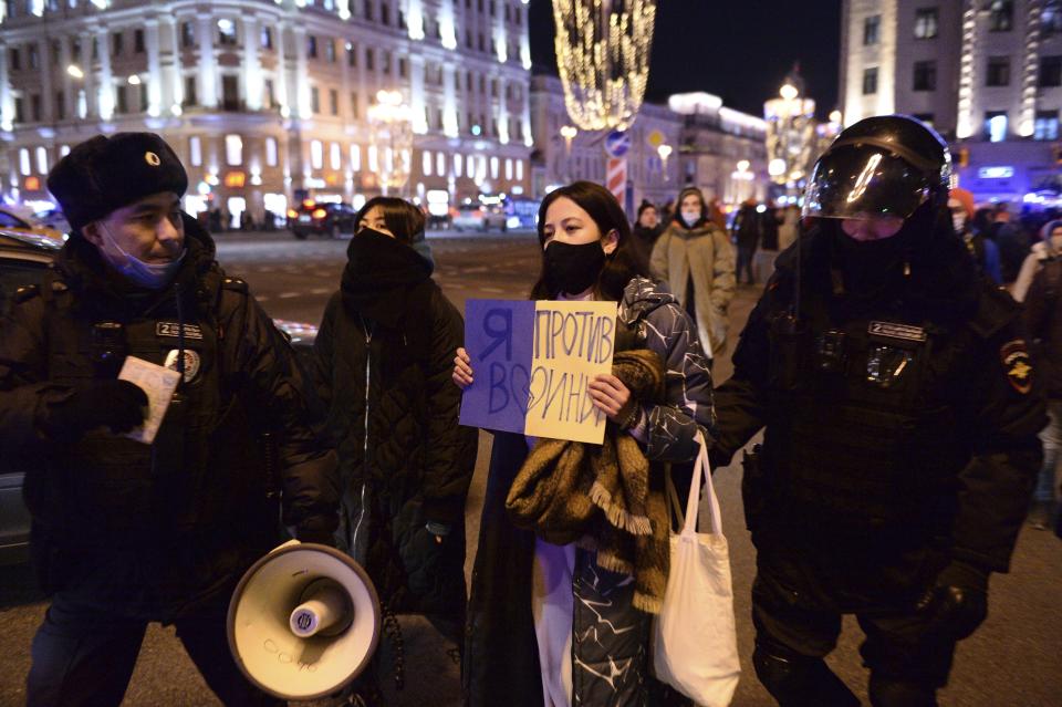 Police officers detain a demonstrator with a poster that reads: "I'm against the war", in Moscow, Russia, Thursday, Feb. 24, 2022, after Russia's attack on Ukraine. Hundreds of people gathered in the center of Moscow on Thursday, protesting against Russia's attack on Ukraine. Many of the demonstrators were detained. Similar protests took place in other Russian cities, and activists were also arrested. (AP Photo/Denis Kaminev)