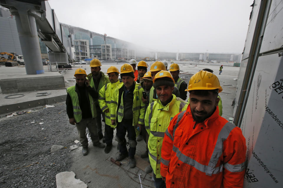 FILE - In this April 13, 2018, file photo, construction workers at Istanbul's third international airport take a break. The first phase of the airport, one of Turkey's President Recep Tayyip Erdogan's major construction projects, is scheduled to be inaugurated on Oct. 29, 2018 when Turkey celebrates Republic Day. The massive project, has been mired in controversy over worker's rights and environmental concerns amid a weakening economy. (AP Photo/Lefteris Pitarakis, File)