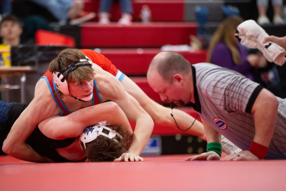 Shawnee Heights' Andrew Bonebrake looks for the pin against Leavenworth's Nathaniel Atwell in their class 138 bout at the United Kansas Conference Championship Saturday, February 3, 2024, inside Shawnee Heights High School.