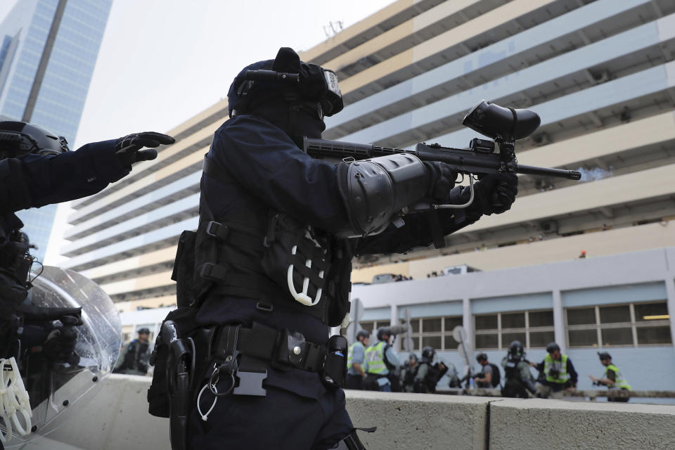 A police officer fires pepper balls during a demonstration in Hong Kong, Saturday, Aug. 24, 2019. Hong Kong protesters skirmished with police on Saturday as chaotic scenes returned to the summer-long protests for the first time in more than a week. (AP Photo/Kin Cheung)