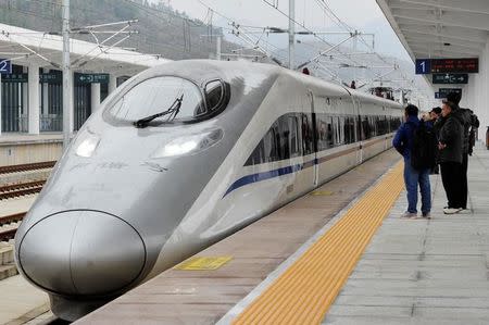 A high-speed railway train linking Shanghai and Kunming, of Yunnan province, is seen at a station during a partial operation, in Anshun, Guizhou province, China, December 28, 2016. Picture taken December 28, 2016. REUTERS/Stringer