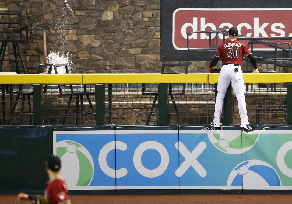 Trayce Thompson watches a home run splash in Chase Field pool during camp in 2020