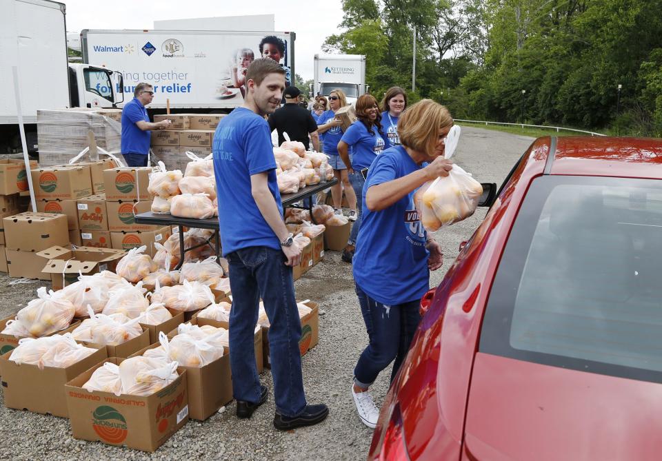 The Dayton Foodbank and Cox Media Group Ohio partnered with the North Dixie Drive In to aid in tornado relief efforts and gave away bottled water and food to those in need on Wednesday at the drive-in on North Dixie Drive.  Bags of fresh oranges were part of the distribution.  WHIO File
