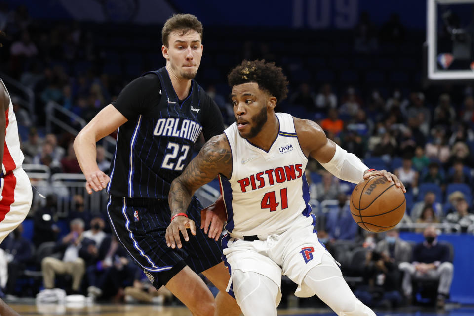 Detroit Pistons forward Saddiq Bey (41) dribbles past Orlando Magic forward Franz Wagner (22) during the first half of an NBA basketball game Friday, Jan. 28, 2022, in Orlando, Fla. (AP Photo/Scott Audette)