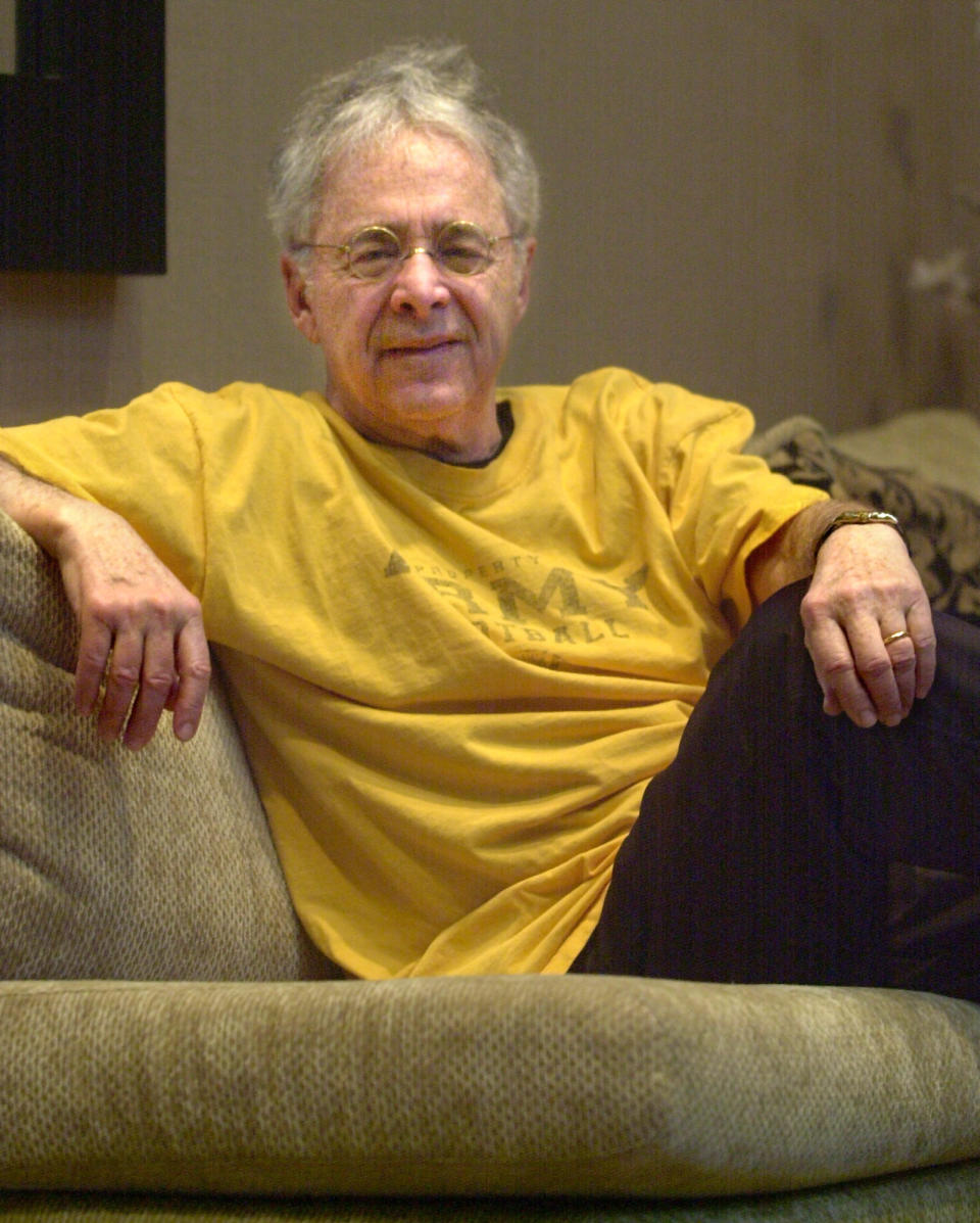 FILE - In this Dec. 20, 2002 file photo, Chuck Barris, the man behind TV's "The Dating Game," poses in the lobby of his apartment in New York. Game show impresario Barris has died at 87. Barris, the madcap producer of "The Gong Show" and "The Dating Game," died of natural causes Tuesday afternoon, March 21, 2017, at his home in Palisades, New York. (AP Photo/Bebeto Matthews, File)