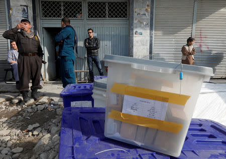 Afghan police officers stand guard while election commission workers prepare ballot boxes and election material at a polling station in Kabul, Afghanistan October 19, 2018. REUTERS/Omar Sobhani