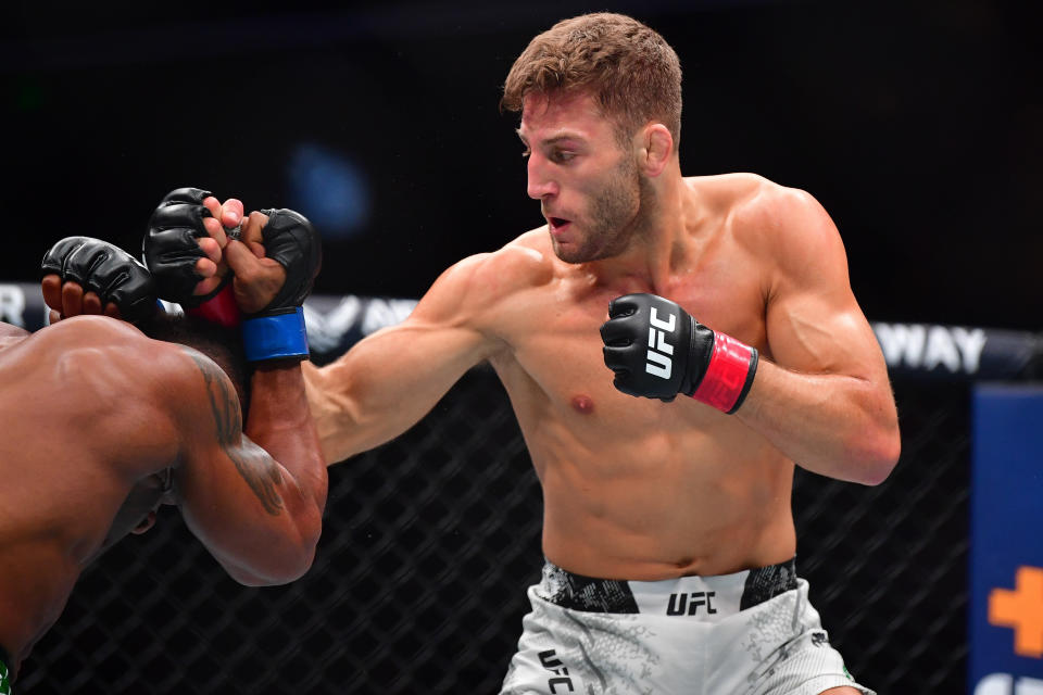 Feb 17, 2024; Anaheim, California, USA; Oban Elliott moves in with a hit against Val Woodburn during UFC 298 at Honda Center. Mandatory Credit: Gary A. Vasquez-USA TODAY Sports