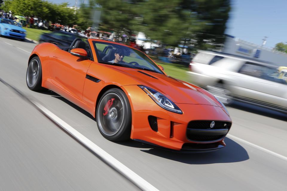 This undated publicity photo provided by Jaguar Land Rover North America, LLC shows a 2014 Jaguar F Type. The two-seat, rear-wheel-drive sports convertible was unveiled at the Paris auto show in 2012 and went on sale in the U.S. earlier this summer. Jaguar says the F Type has the company’s most advanced use of lightweight aluminum to date, giving it a stiffer and more dynamic ride. (AP Photo/Jaguar Land Rover North America, LLC, Regis Lefebure)