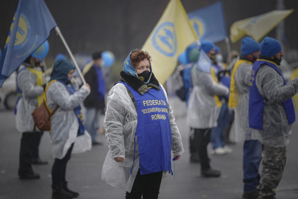 FILE - Health workers take part in a protest outside the government building in Bucharest, Romania, Tuesday, Dec. 28, 2021. As the fast-spreading coronavirus variant omicron rages through Western Europe, officials and experts in low-vaccinated Eastern Europe view it as a forewarning for what much of the region anticipates to be an imminent, post-holiday virus surge.(AP Photo/Vadim Ghirda. File)