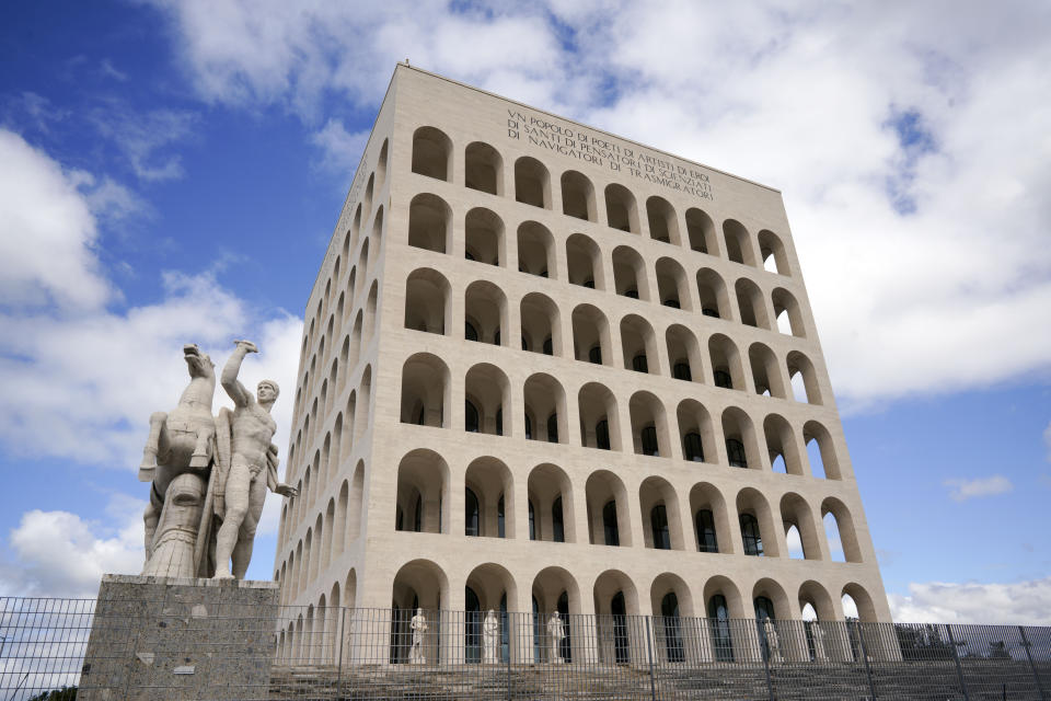 This May 6, 2019 photo shows and exterior view of the Palazzo della Civiltà' building in Rome's EUR neighborhood. Italy never went through a period that could be likened to Germany’s de-Nazification. Mussolini was in power for nearly two decades before Italy entered World War II, a period of modernization during which the fascist regime built schools, railroad stations and administrative buildings in the distinctive spare architectural style that remain in public use today. (AP Photo/Andrew Medichini)