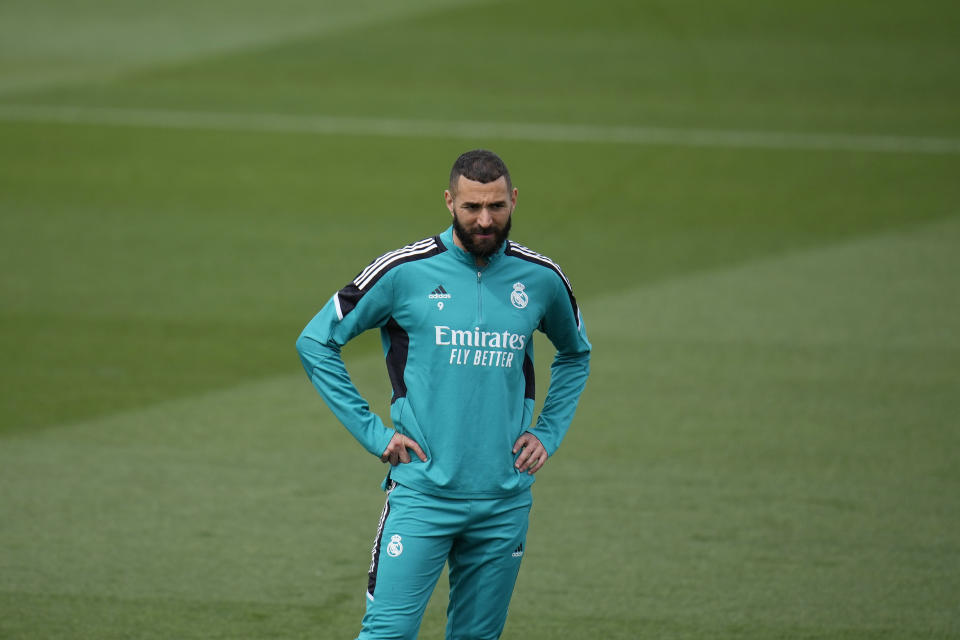 Real Madrid's Karim Benzema stands on the pitch during a Media Opening day training session in Madrid, Spain, Tuesday, May 24, 2022. Real Madrid will play Liverpool in Saturday's Champions League soccer final in Paris. (AP Photo/Manu Fernandez)