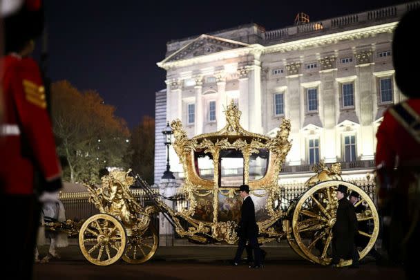 PHOTO: The Gold State Coach is driven alongside members of the military during a full overnight dress rehearsal of the coronation procession for Britain's King Charles and Camilla, Queen Consort, in London, May 3, 2023. (Henry Nicholls/Reuters)