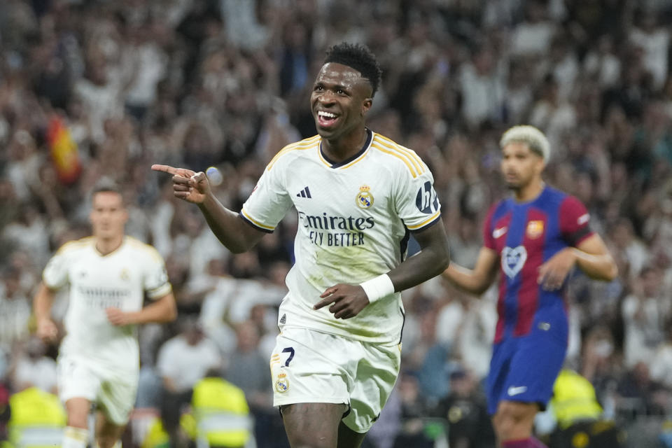 Real Madrid's Vinicius Junior celebrates after scoring his side's opening goal during the Spanish La Liga soccer match between Real Madrid and Barcelona at the Santiago Bernabeu stadium in Madrid, Spain, Sunday, April 21, 2024. (AP Photo/Manu Fernandez)