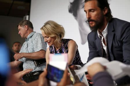 Cast members Naomi Watts (C) and Matthew McConaughey (R), and director Gus Van Sant (L) sign autographs after a news conference for the film "The Sea of Trees" in competition at the 68th Cannes Film Festival in Cannes, southern France, May 16, 2015. REUTERS/Benoit Tessier