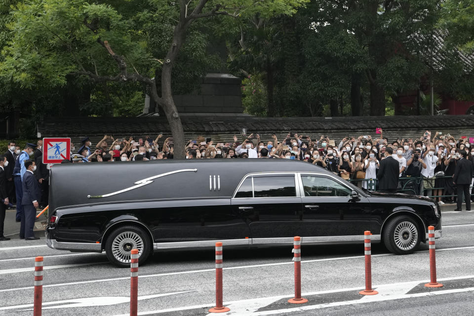 The vehicle carrying the body of former Japanese Prime Minister Shinzo Abe leaves Zojoji temple after his funeral in Tokyo on Tuesday, July 12, 2022. Abe was assassinated Friday while campaigning in Nara, western Japan. (AP Photo/Hiro Komae)