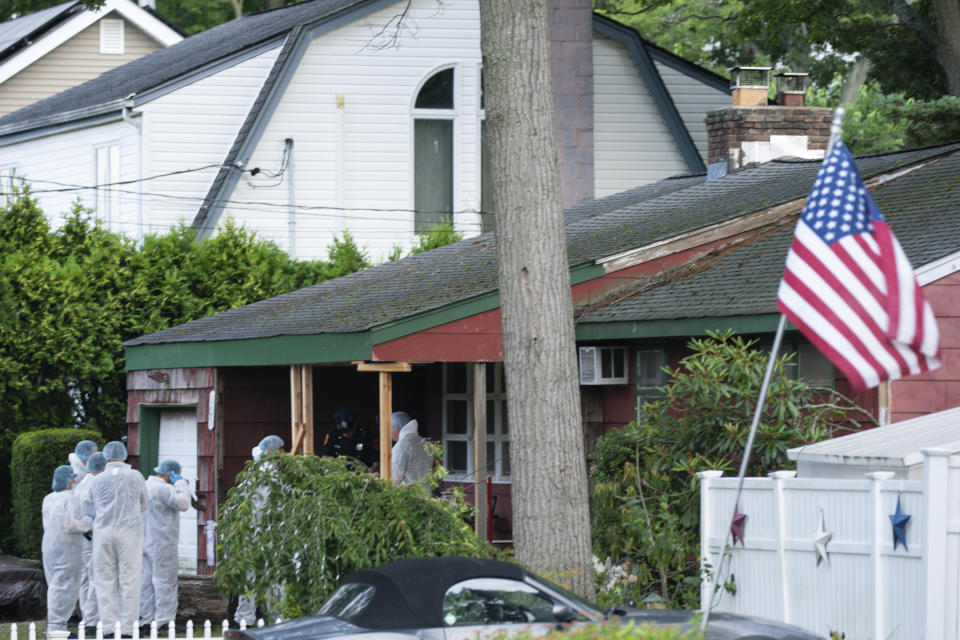 Crime laboratory officers arrive at the house where a suspect was taken into custody on New York's Long Island in connection with a long-unsolved string of serial killings, known as the Gilgo Beach murders, July 14, 2023, in Massapequa Park, New York. / Credit: Eduardo Munoz Alvarez / AP