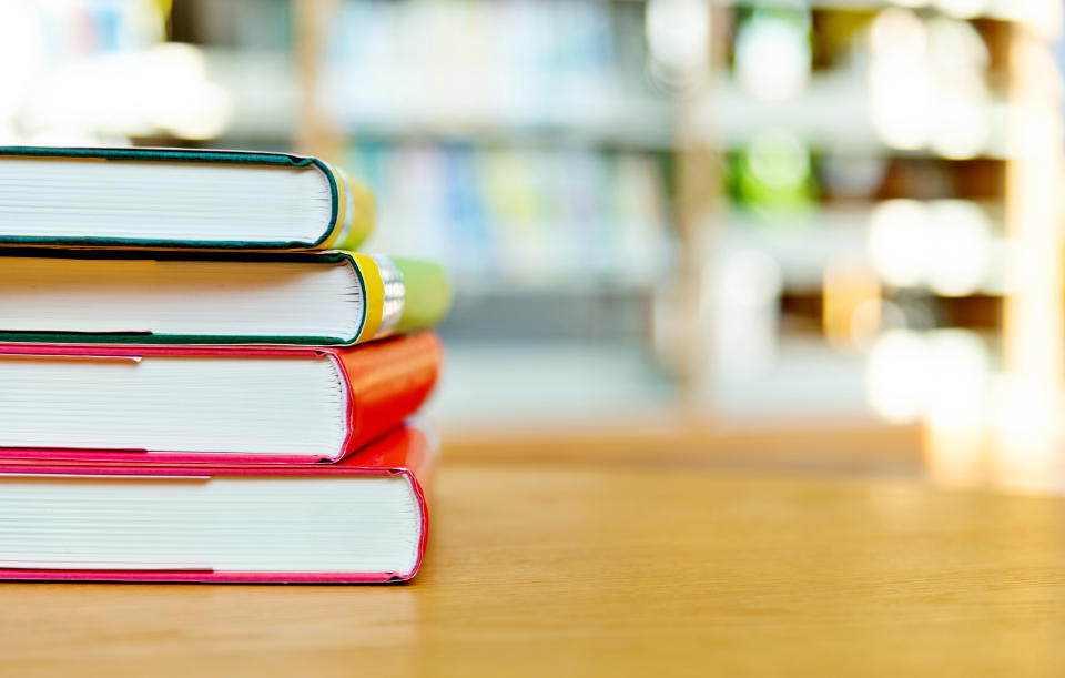 Stack of  books on the table of public library.