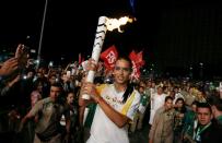 <p>Model Adriana Lima carries the Olympic torch in Maua Square in Rio de Janeiro, Brazil, August 4, 2016. REUTERS/Pilar Olivares </p>