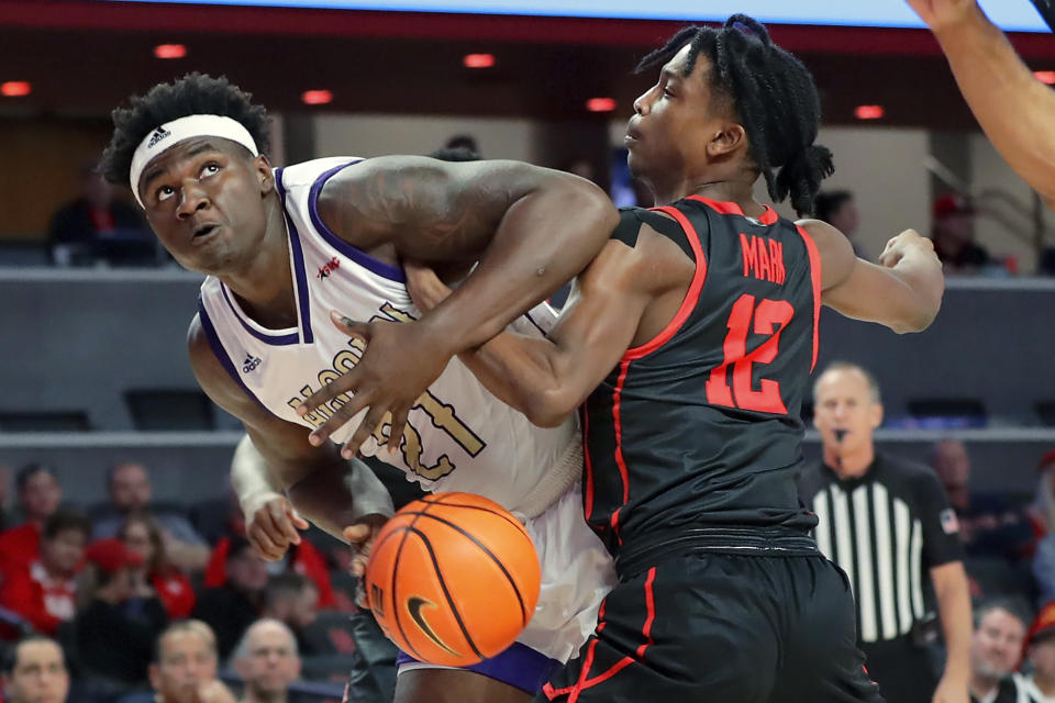 Alcorn State forward Ladarius Marshall (21) has the ball knocked away on a shot attempt by Houston guard Tramon Mark (12) during the first half of an NCAA college basketball game, Monday, Dec. 6, 2021, in Houston. (AP Photo/Michael Wyke)