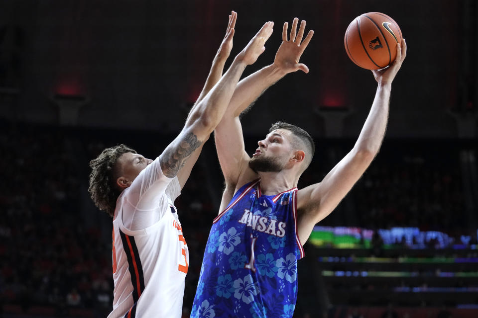 Kansas center Hunter Dickinson shoots over Illinois forward Coleman Hawkins during the second half of the NCAA college basketball exhibition game Sunday, Oct. 29, 2023, in Champaign, Ill. Illinois won 82-75. (AP Photo/Charles Rex Arbogast)
