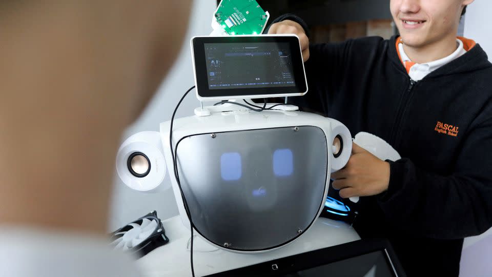 High school students work on "Alnstein", a robot powered by ChatGPT, in Pascal school in Nicosia, Cyprus on March 30, 2023. - Yiannis Kourtoglou/Reuters