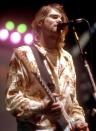 <p>Kurt Cobain performs in Belfast in 1992. Among his many notable style elements were printed silk pajama shirts, as seen here.</p>