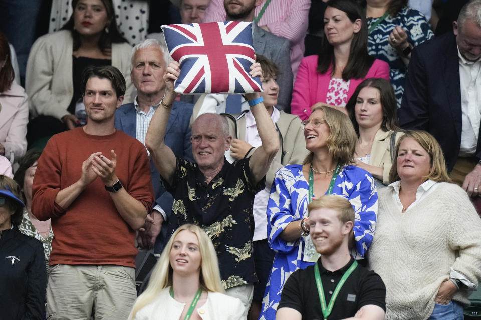 Supporters of Britain's Emma Raducanu react after her win over Elise Mertens of Belgium in their match on day three at the Wimbledon tennis championships in London, Wednesday, July 3, 2024. (AP Photo/Mosa'ab Elshamy)