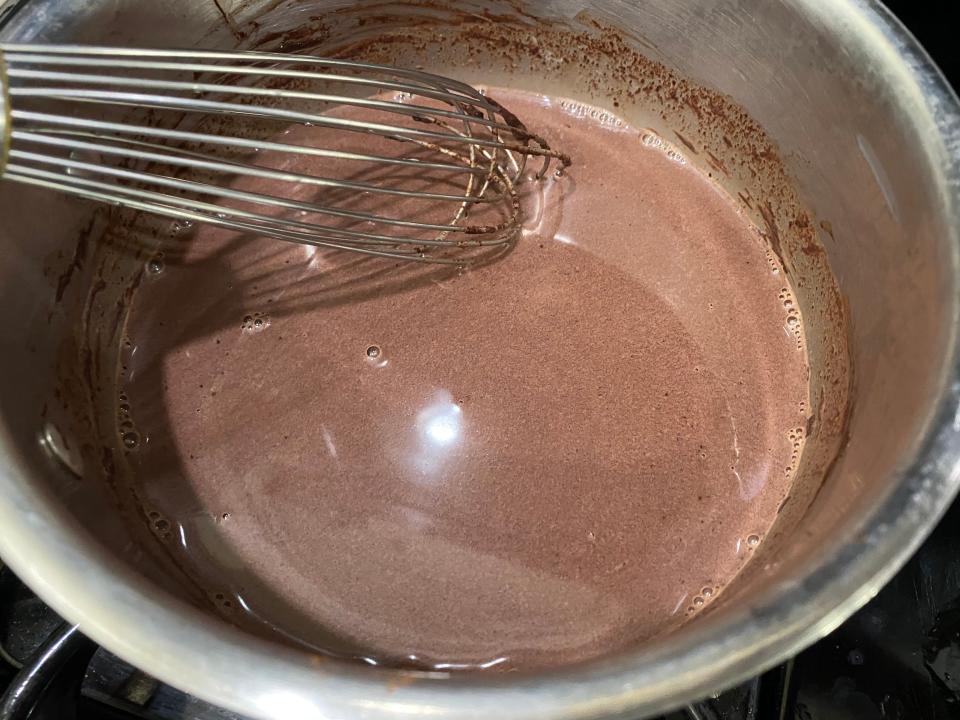 mixing Carla Hall hot chocolate in pan over stove