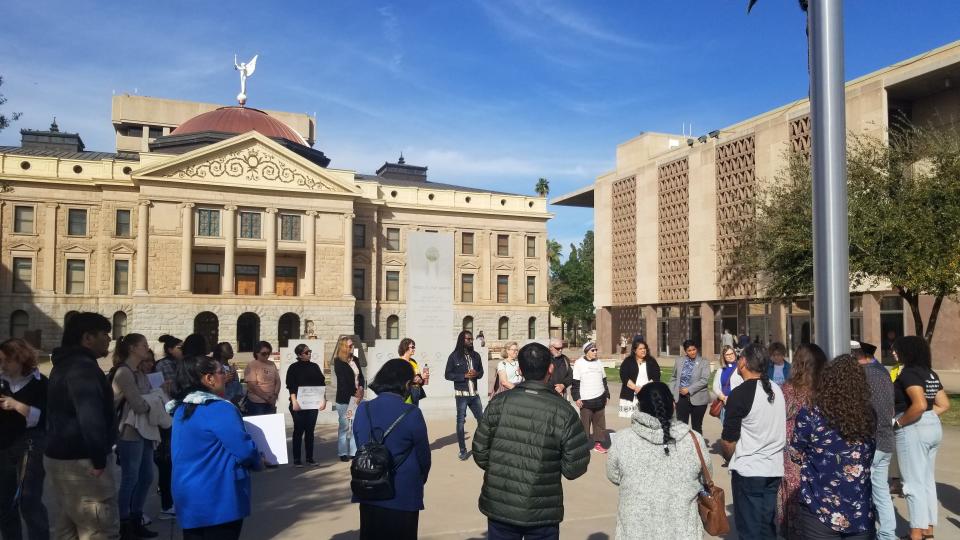 An interfaith gathering on Feb. 27, 2024 is seen outside the Arizona Capitol in a prayer circle in response to legislation aimed at unauthorized immigration.