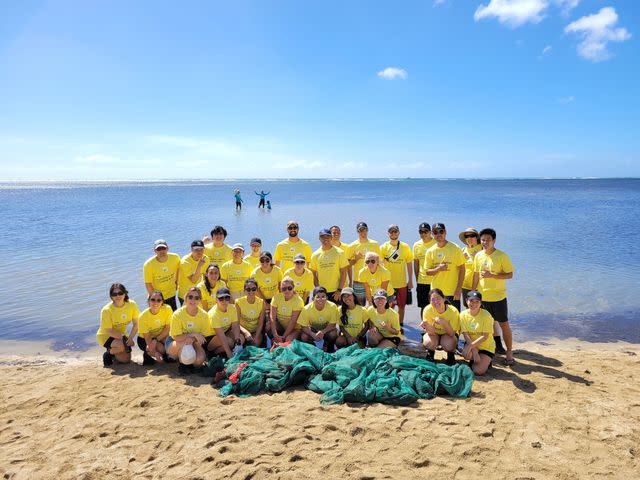 <p>Ey</p> EY volunteers clean a beach in Honolulu as part of EY Connect Day.