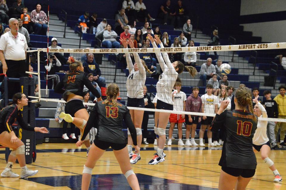 Airport's Chloe Ruhlig (14) and Jillian Baker (6) go up for a block against Riverview on Wednesday, October 18, 2023 at Airport.