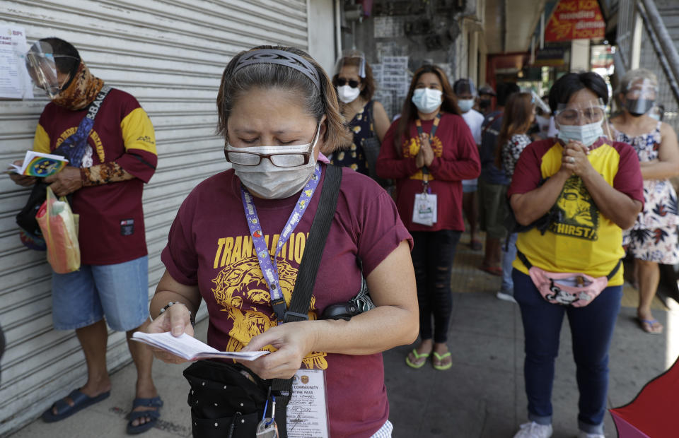 Devotees offers prayers outside the Quiapo Church on Good Friday, April 2, 2021 as the government implements a strict lockdown to prevent the spread of the coronavirus in Manila, Philippines. Filipinos marked Jesus Christ's crucifixion Friday in one of the most solemn holidays in Asia's largest Catholic nation which combined with a weeklong coronavirus lockdown to empty Manila's streets of crowds and heavy traffic jams. Major highways and roads were eerily quiet on Good Friday and churches were deserted too after religious gatherings were prohibited in metropolitan Manila and four outlying provinces. (AP Photo/Aaron Favila)