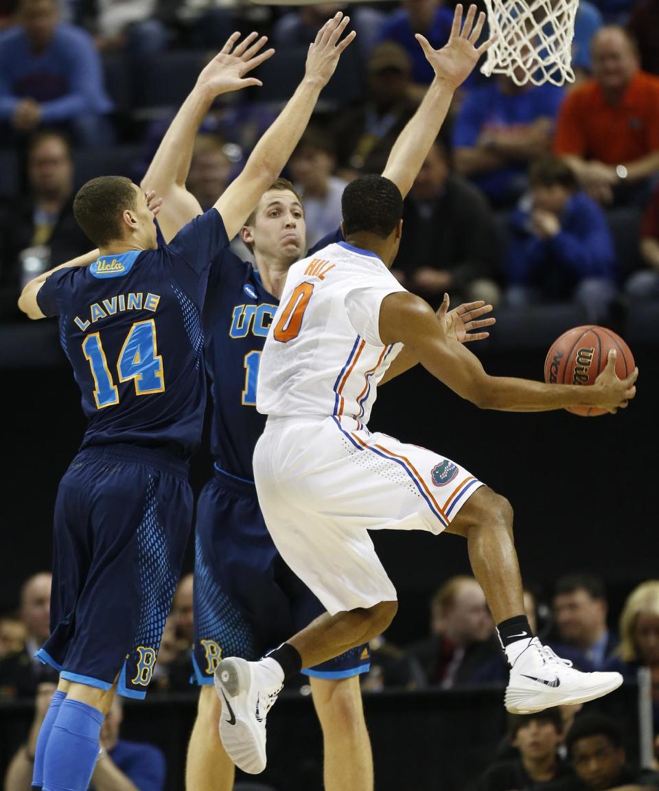 UCLA's Zach LaVine (14) and David Wear (12) defend against Florida Kasey Hill (0) during the first half in a regional semifinal game at the NCAA college basketball tournament, Thursday, March 27, 2014, in Memphis, Tenn. (AP Photo/John Bazemore)