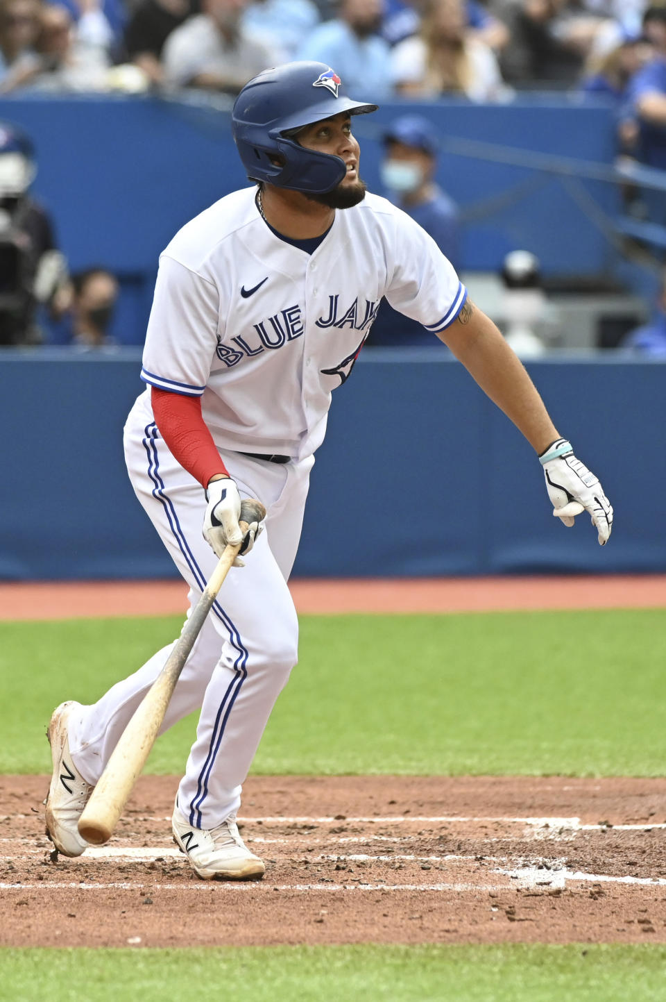 Toronto Blue Jays' Breyvic Valera watches his two-run home run in the fourth inning of a baseball game against the Oakland Athletics in Toronto on Saturday, Sept. 4, 2021. (Jon Blacker/The Canadian Press via AP)