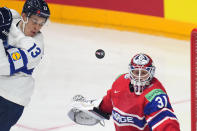 Norway's Jonas Arntzen, right, makes a save against Finland's Jesse Puljujarvi during the preliminary round match between Finland and Norway at the Ice Hockey World Championships in Prague, Czech Republic, Monday, May 13, 2024. (AP Photo/Petr David Josek)