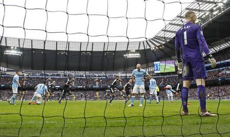 Football - Manchester City v Leicester City - Barclays Premier League - Etihad Stadium - 6/2/16 Leicester City's Robert Huth celebrates scoring their third goal as Manchester City players look dejected Action Images via Reuters / Jason Cairnduff Livepic