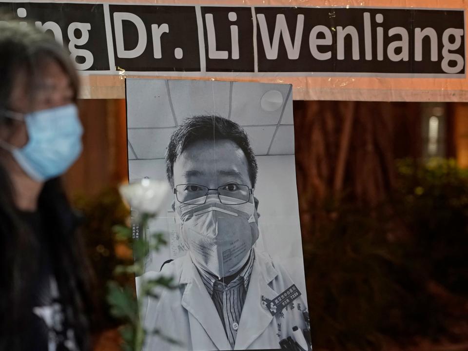 Pro-democracy activist Leung Kwok-hung, wearing a mask, attends a vigil for Chinese doctor Li Wenliang, in Hong Kong, Friday, Feb. 7, 2020. The death of a young doctor who was reprimanded for warning about China's new virus triggered an outpouring Friday of praise for him and fury that communist authorities put politics above public safety. (AP Photo/Kin Cheung)