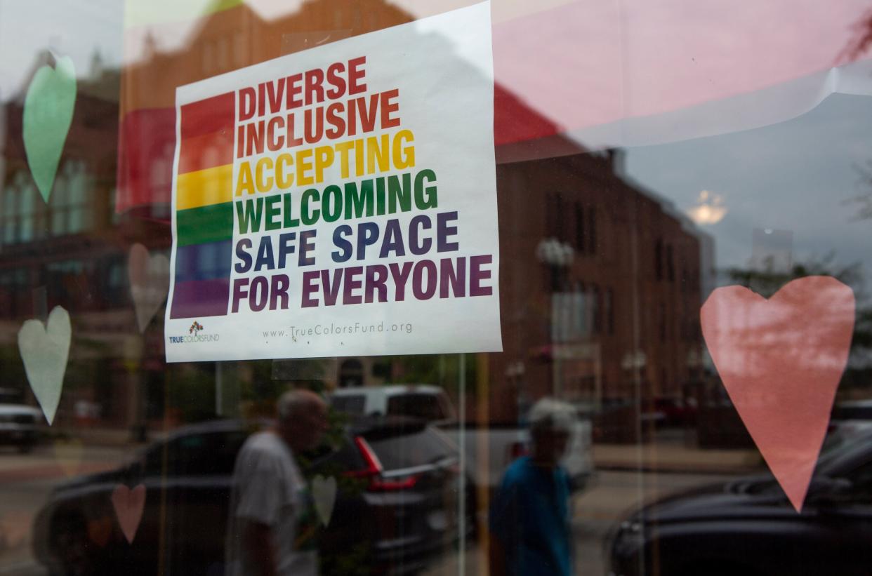 A Pride sign is displayed in the front window of the Integrated Services for Behavioral Health business in downtown Lancaster, Ohio in 2021.