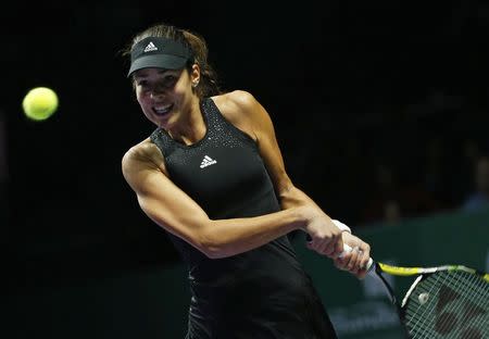 Ana Ivanovic of Serbia hits a return to Eugenie Bouchard of Canada during their WTA Finals singles tennis match at the Singapore Indoor Stadium October 22, 2014. REUTERS/Edgar Su