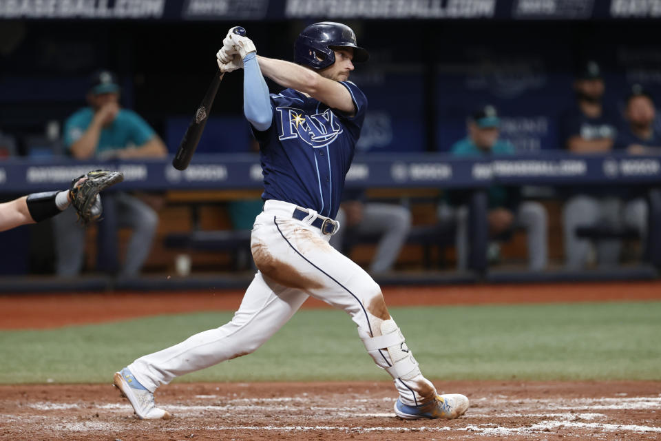 Tampa Bay Rays' Brandon Lowe watches the ball after hitting a two-run RBI double against the Seattle Mariners during the fifth inning of a baseball game Saturday, Sept. 9, 2023, in St. Petersburg, Fla. (AP Photo/Scott Audette)