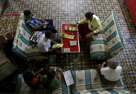 A voter (R) waits for his ballot in his home during a door-to-door advance vote collection in Yangon November 7, 2015. REUTERS/Soe Zeya Tun