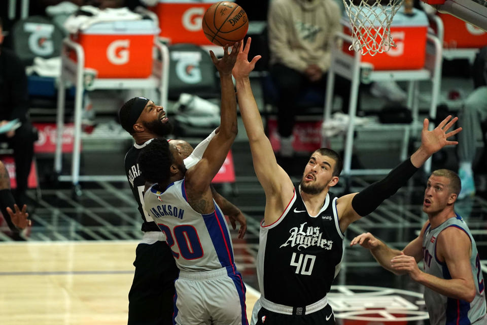 Detroit Pistons guard Josh Jackson (20) is defended by LA Clippers center Ivica Zubac (40) and forward Marcus Morris Sr. (8) in the first half April 11, 2021 at Staples Center.