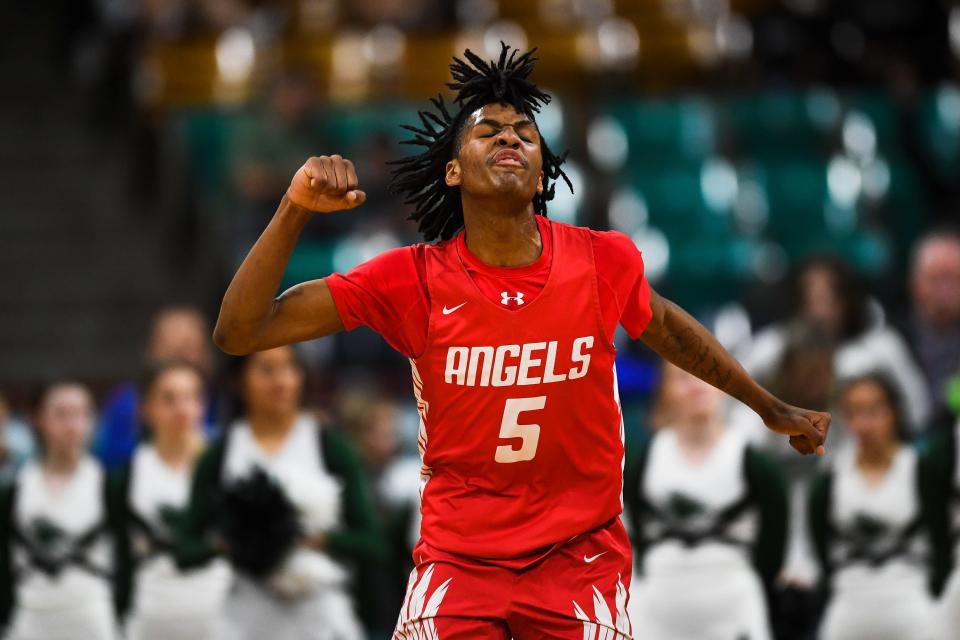 Denver East's D'Aundre Samuels (5) celebrates after a made shot against Fossil Ridge during the 6A state championship at the Denver Coliseum on Saturday, March 11, 2023, in Denver, Colo. Denver East won 82-61.