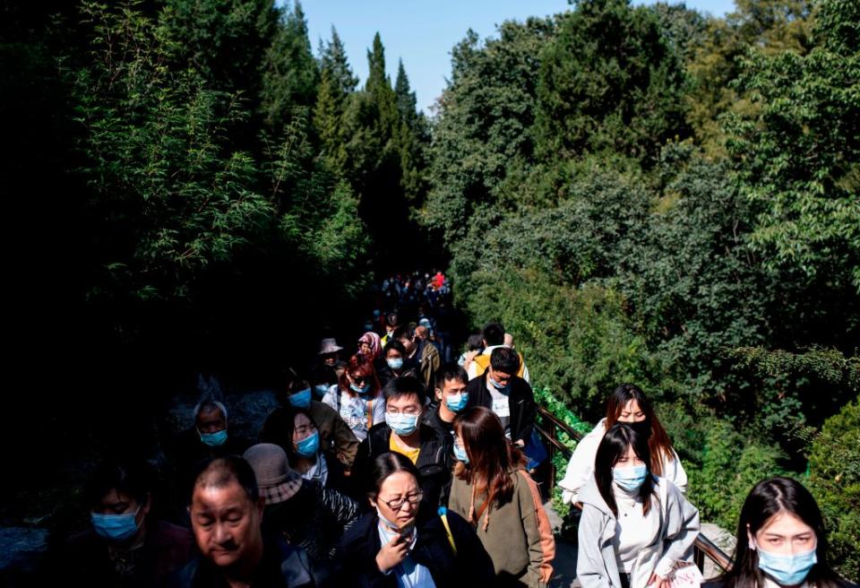 Pictured are hundreds of people at Jingshan Park in Beijing during the country's national "Golden Week" holiday.