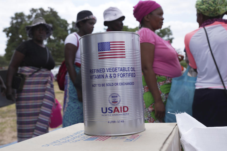 Women wait in a queue to receive food aid in Mangwe district in southwestern Zimbabwe, Friday, March, 22, 2024. A new drought has left millions facing hunger in southern Africa as they experience the effects of extreme weather that scientists say is becoming more frequent and more damaging. (AP Photo/Tsvangirayi Mukwazhi)