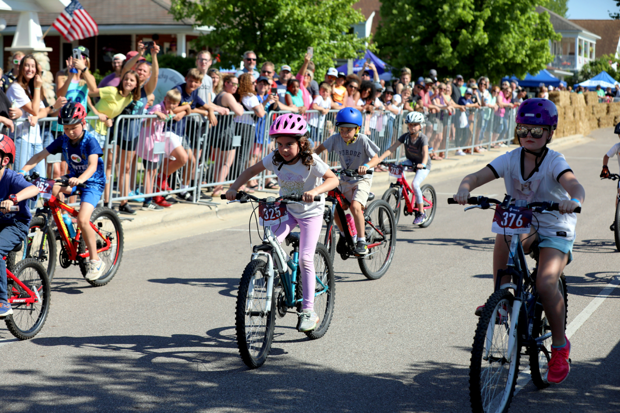 Young bicyclists start the kids race around the island in Winona Lake during the 2023 Fat & Skinny Tire Fest.