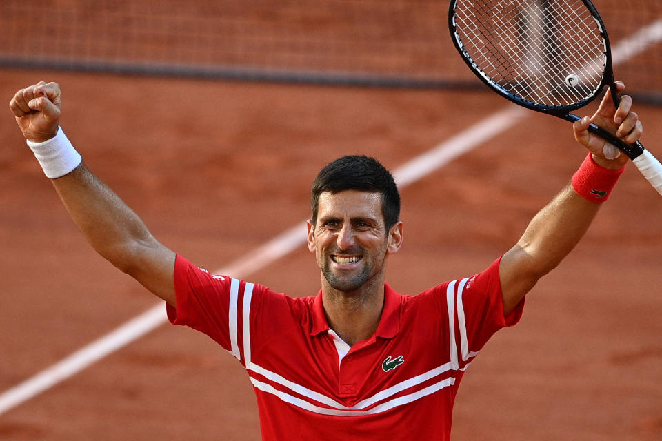 TOPSHOT - Serbia's Novak Djokovic celebrates after winning against Greece's Stefanos Tsitsipas at the end of their men's final tennis match on Day 15 of The Roland Garros 2021 French Open tennis tournament in Paris on June 13, 2021. (Photo by Christophe ARCHAMBAULT / AFP) (Photo by CHRISTOPHE ARCHAMBAULT/AFP via Getty Images)